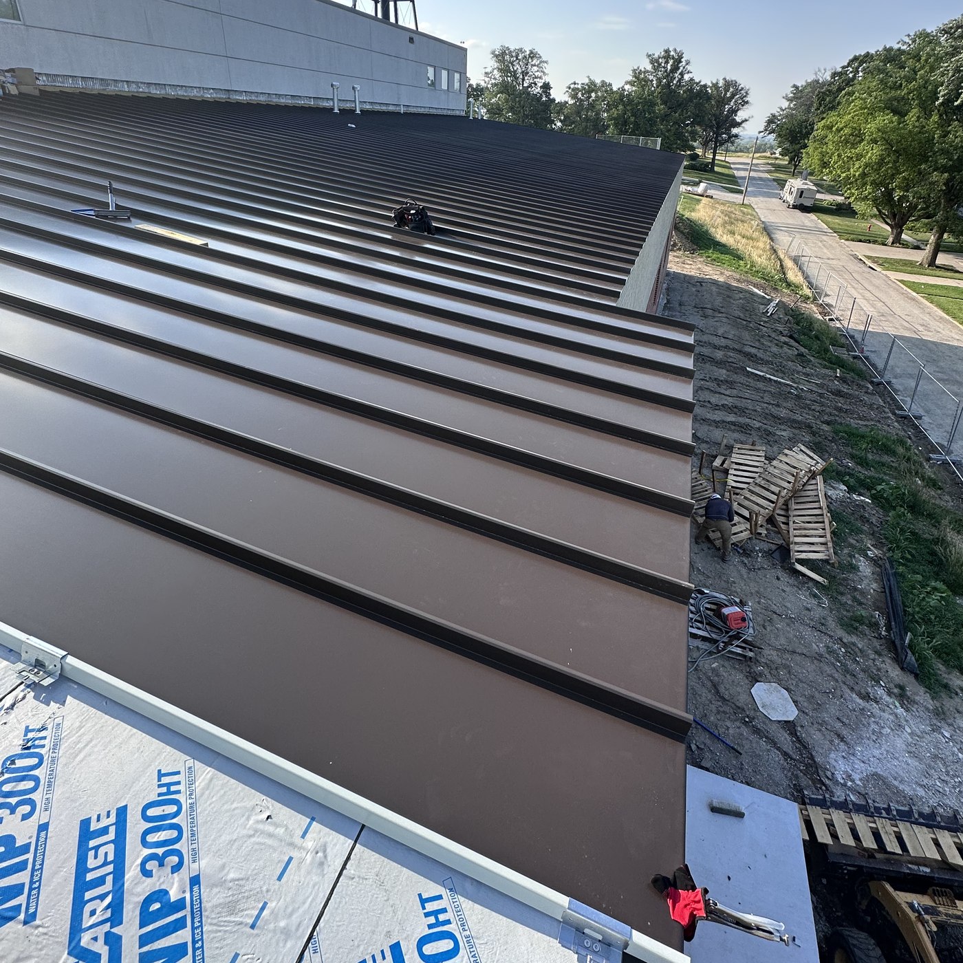 Standing seam metal roof detail inspected for repair
